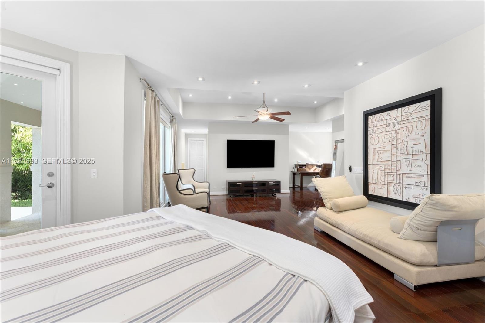 12801 Old Cutler Road Pinecrest, FL 33156 - Photo 28 of 56 a bedroom with bed a flat screen tv and a couch