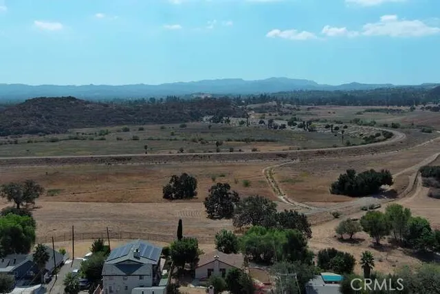 a view of empty room with a fireplace and window