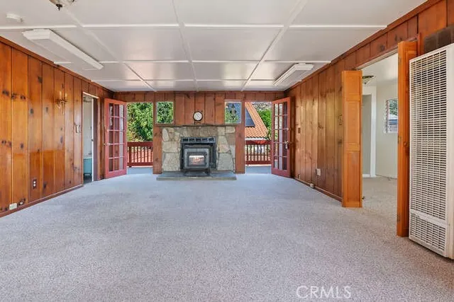 a view of an empty room with a fireplace