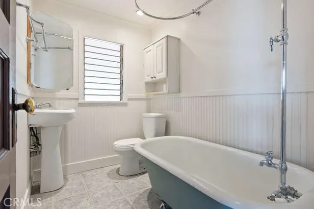 a view of an empty room with a fireplace and a window