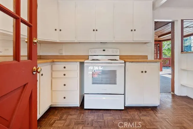 a kitchen with white cabinets and white appliances