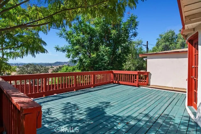 a view of a wooden deck with a yard