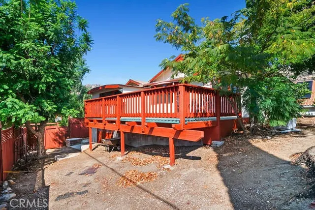 a backyard of a house with barbeque oven table and chairs