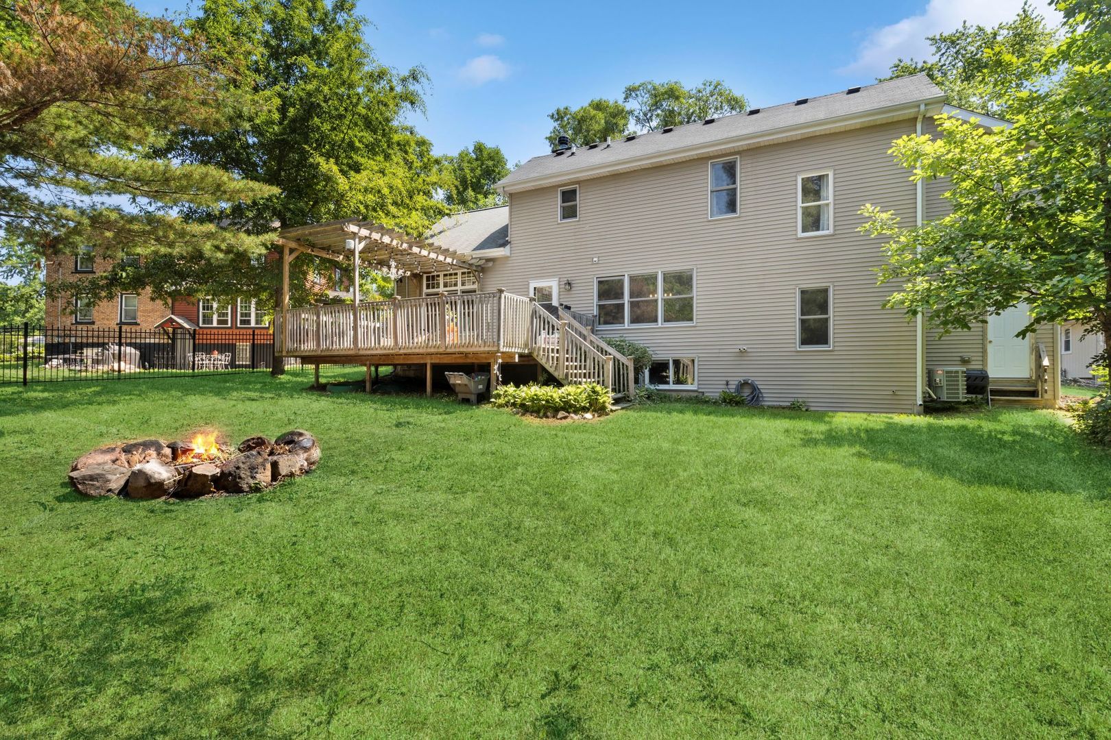 4407 Maple Leaf Drive Johnsburg, IL 60051 - Photo 17 of 17 a front view of a house with a yard and trees