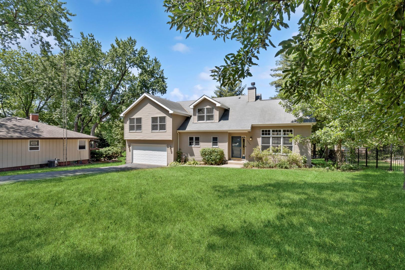 4407 Maple Leaf Drive Johnsburg, IL 60051 - Photo 2 of 17 a front view of a house with a garden