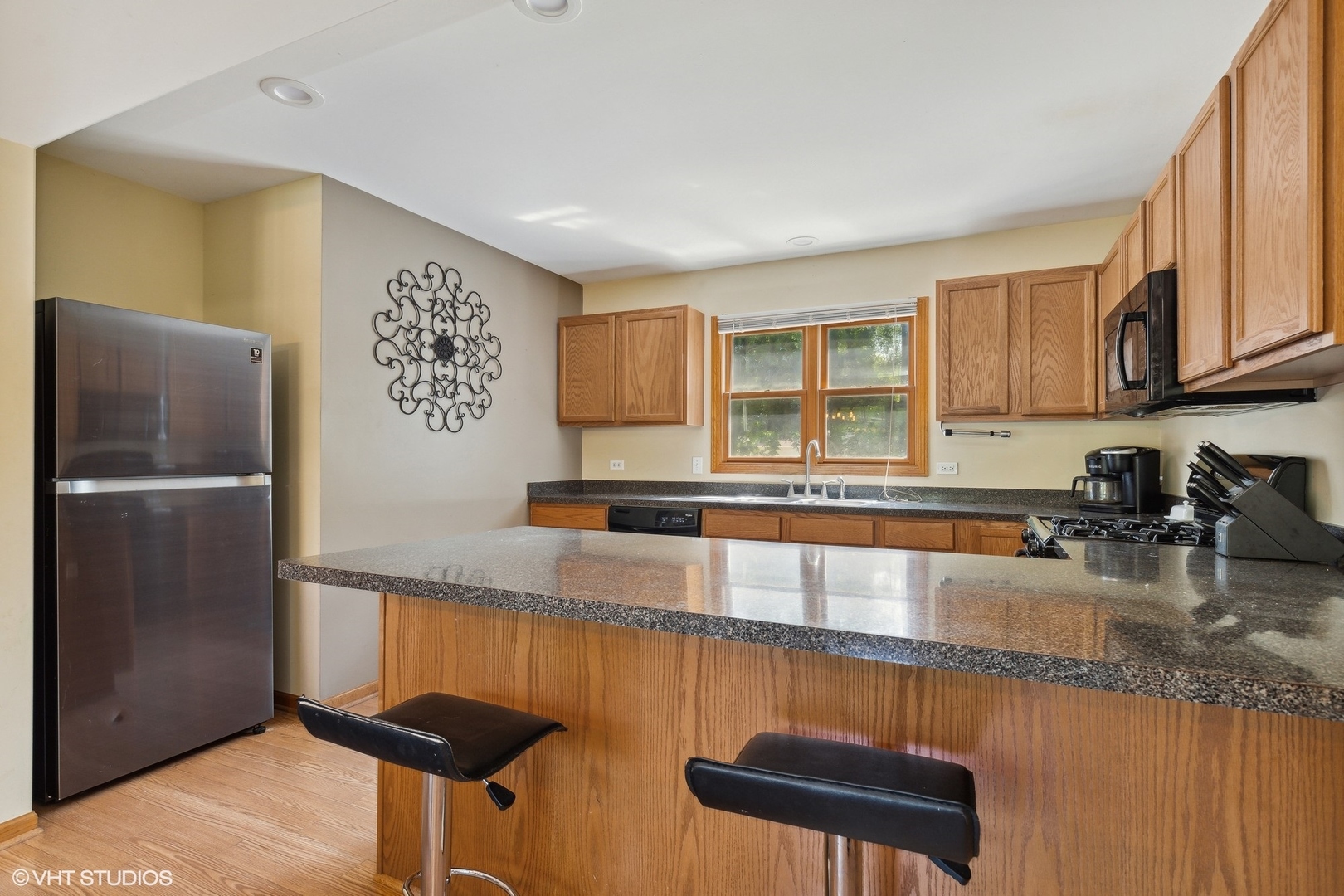 4407 Maple Leaf Drive Johnsburg, IL 60051 - Photo 7 of 17 a kitchen with granite countertop a refrigerator a stove and a sink