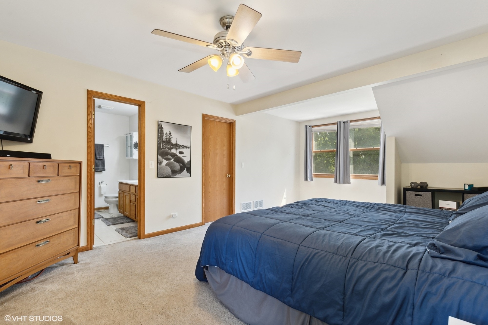 4407 Maple Leaf Drive Johnsburg, IL 60051 - Photo 8 of 17 a bedroom with a large bed and a flat tv screen on dresser