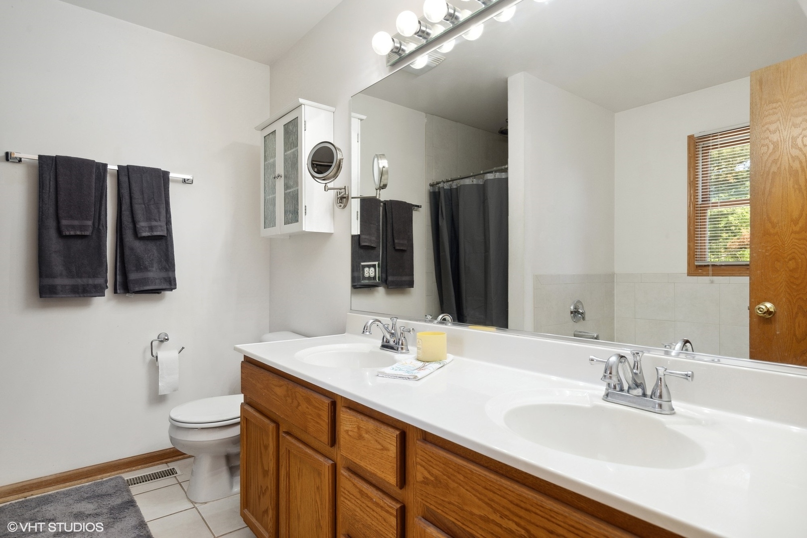 4407 Maple Leaf Drive Johnsburg, IL 60051 - Photo 9 of 17 a bathroom with a granite countertop sink mirror and toilet