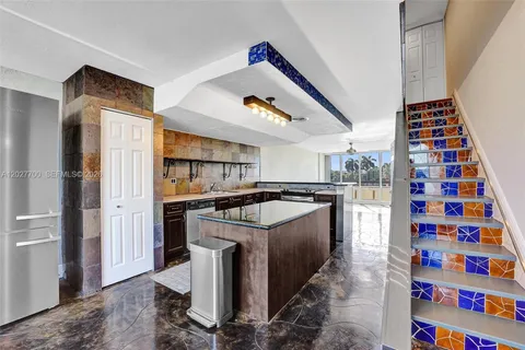 a kitchen with stove and refrigerator