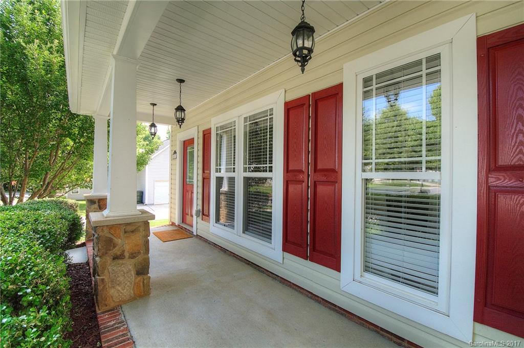 8813 Washam Potts Road Cornelius, NC 28031 - Photo 2 of 24 a view of a porch with a table and chairs