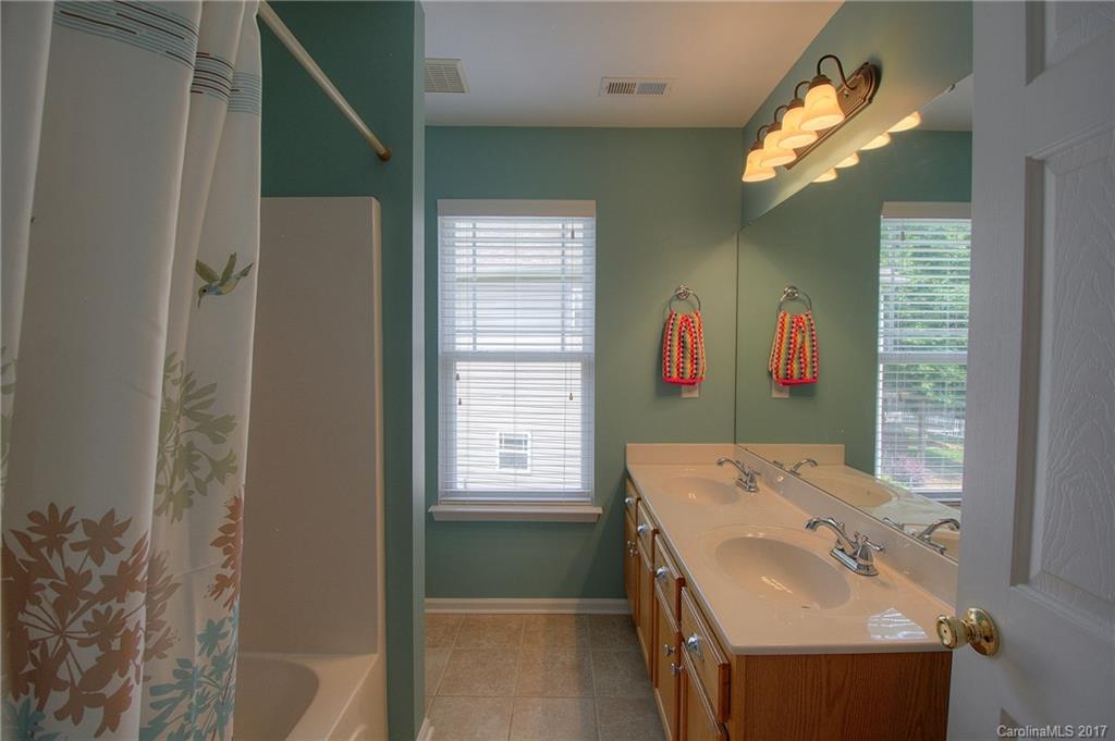 8813 Washam Potts Road Cornelius, NC 28031 - Photo 12 of 24 a bathroom with a sink and a mirror
