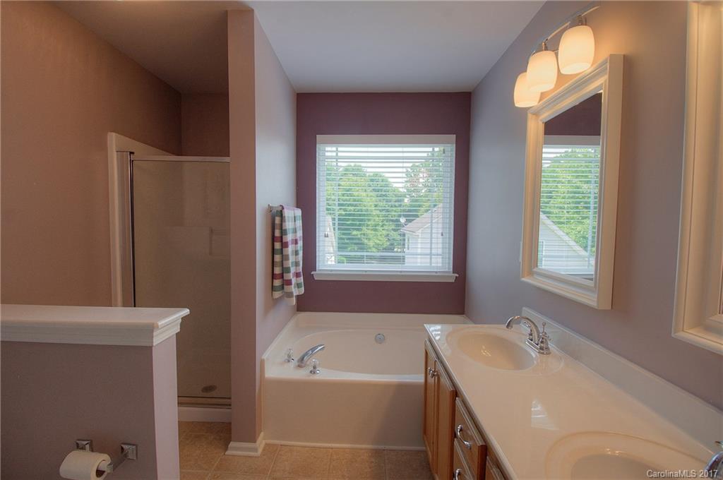 8813 Washam Potts Road Cornelius, NC 28031 - Photo 16 of 24 a bathroom with a tub sink and a window