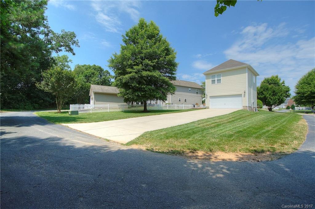 8813 Washam Potts Road Cornelius, NC 28031 - Photo 21 of 24 a view of a house with a yard and garage