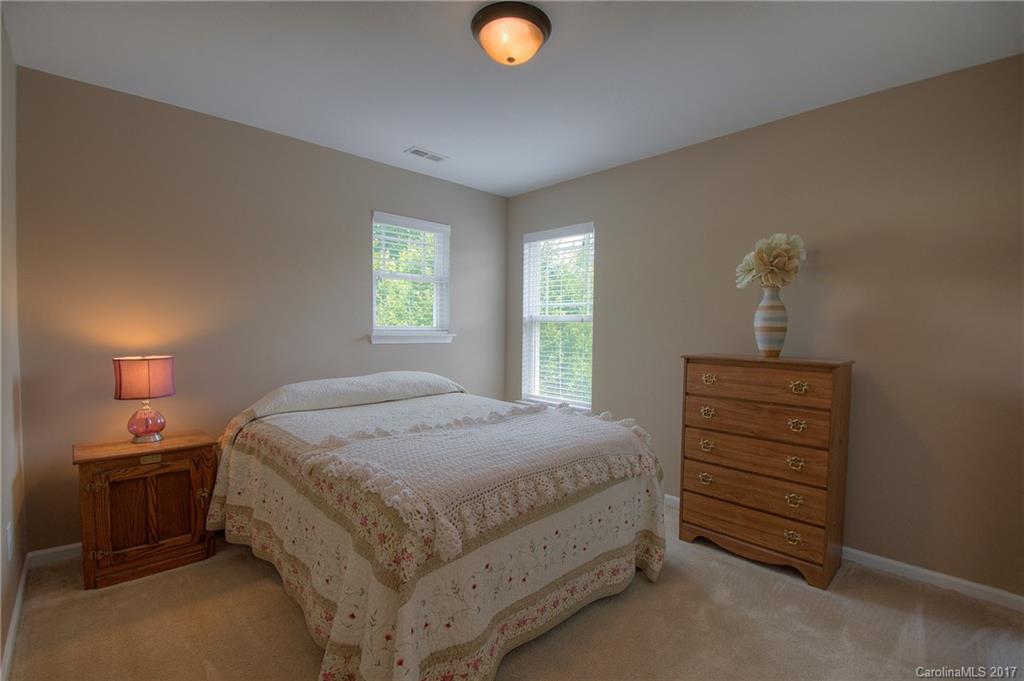 8813 Washam Potts Road Cornelius, NC 28031 - Photo 10 of 24 a bedroom with a bed and a window