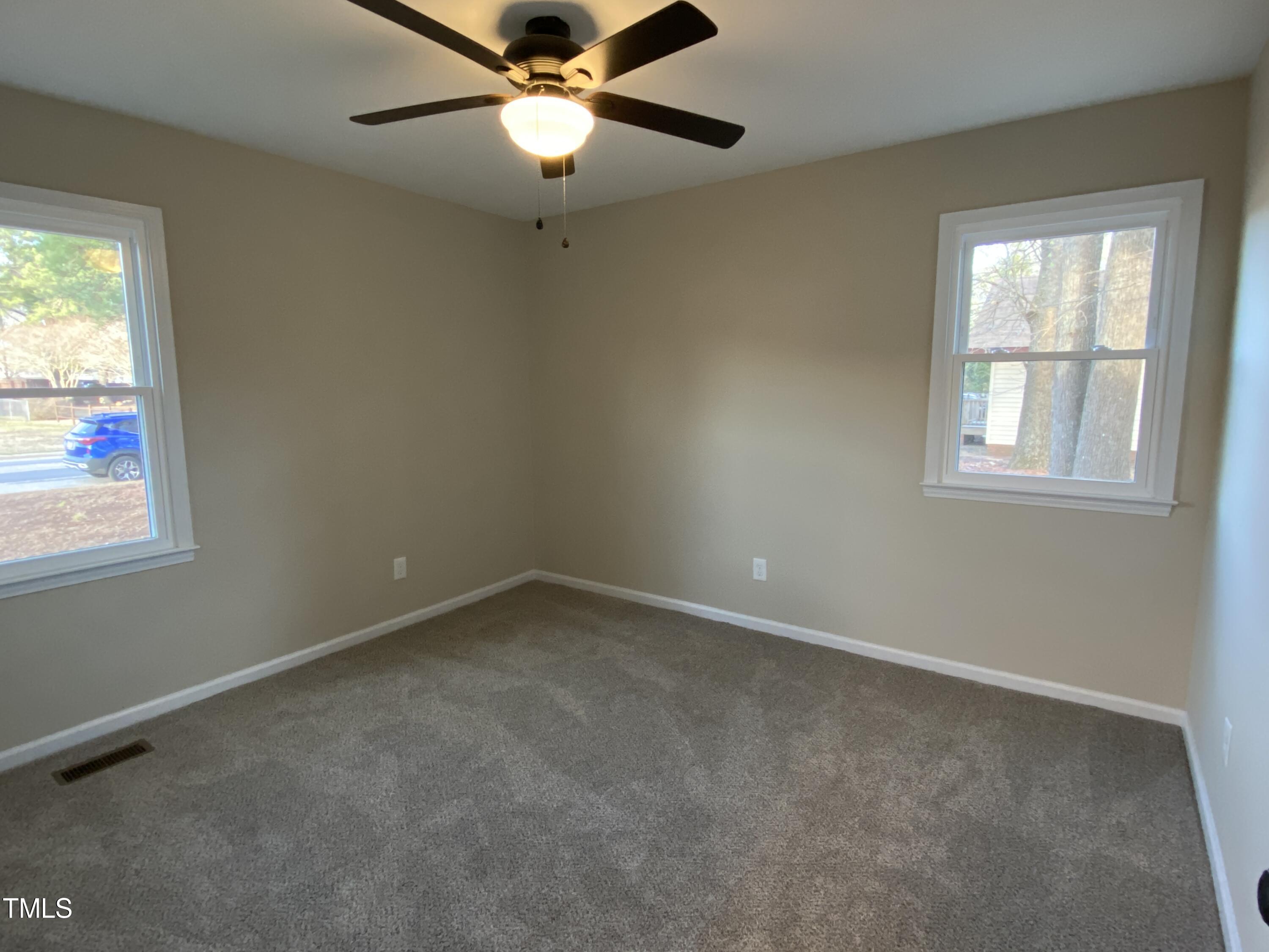 110 Sycamore Street Dunn, NC 28334 - Photo 17 of 28 an empty room with a window and a fan