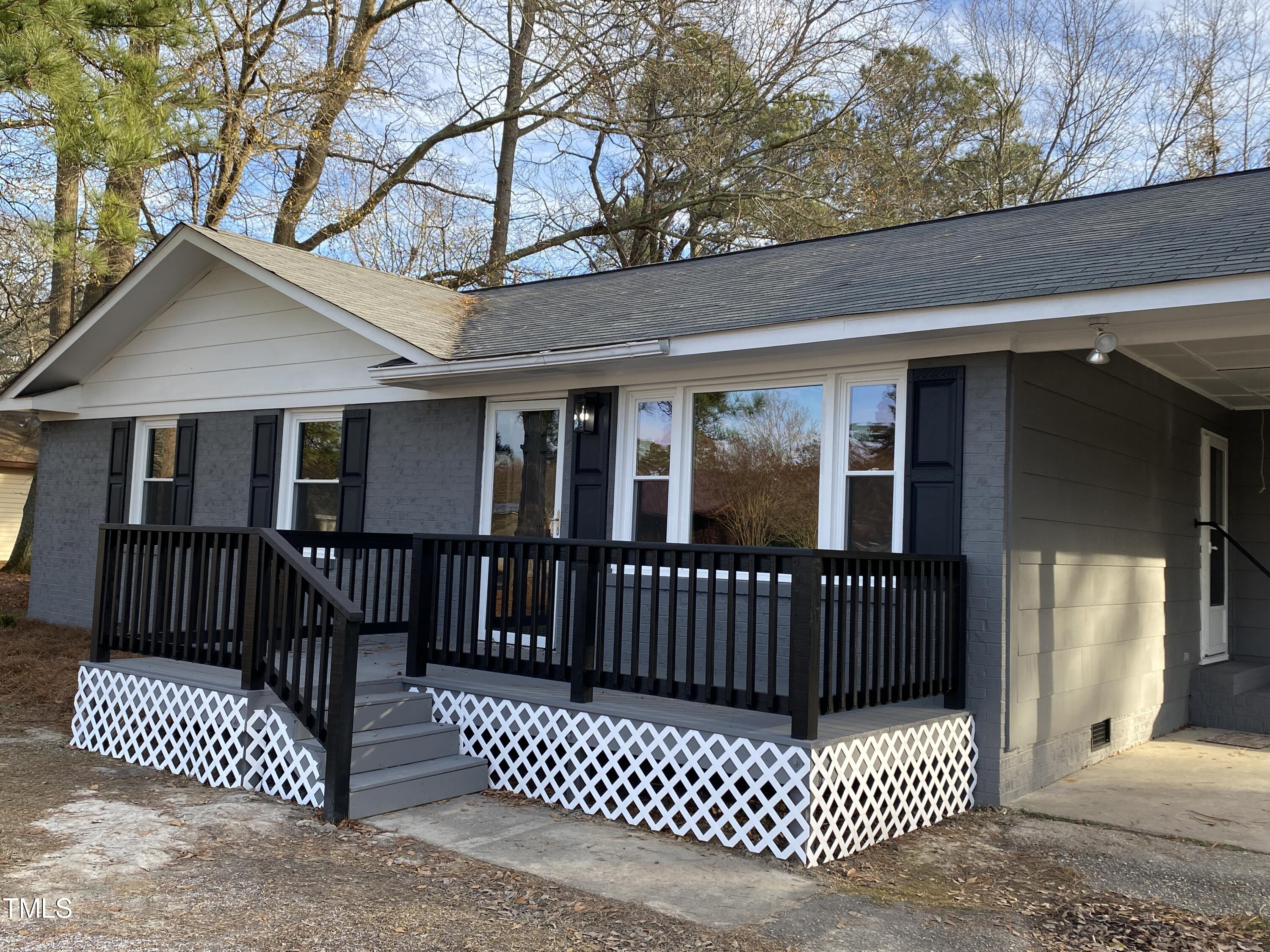 110 Sycamore Street Dunn, NC 28334 - Photo 2 of 28 a view of a brick house with a large window