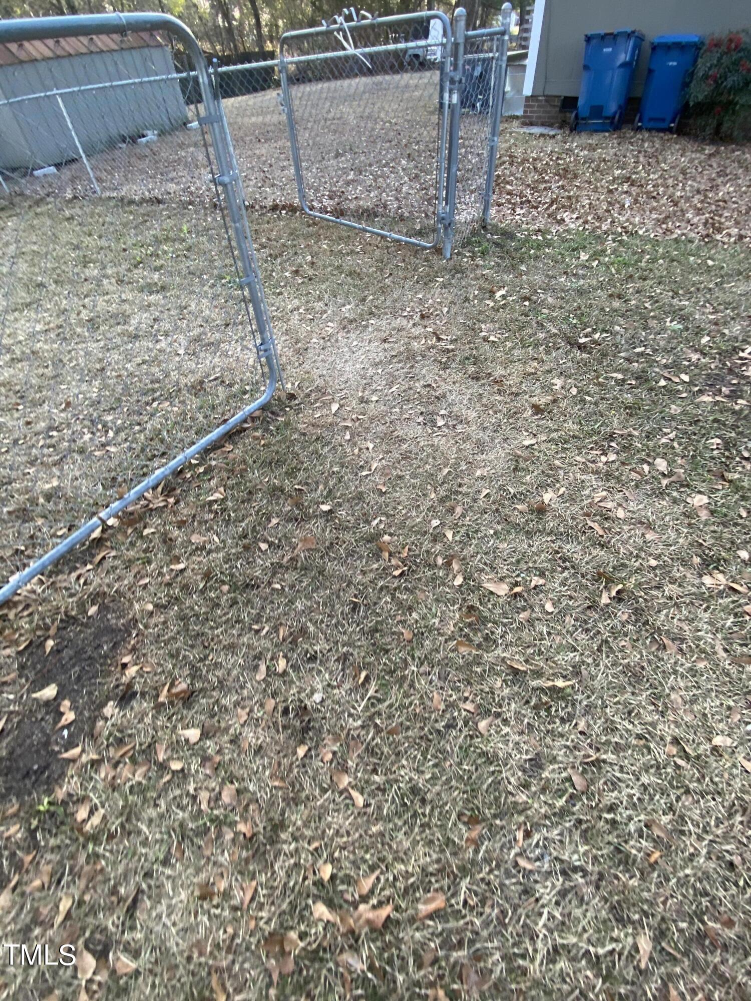 110 Sycamore Street Dunn, NC 28334 - Photo 24 of 28 a view of a dry yard with wooden fence
