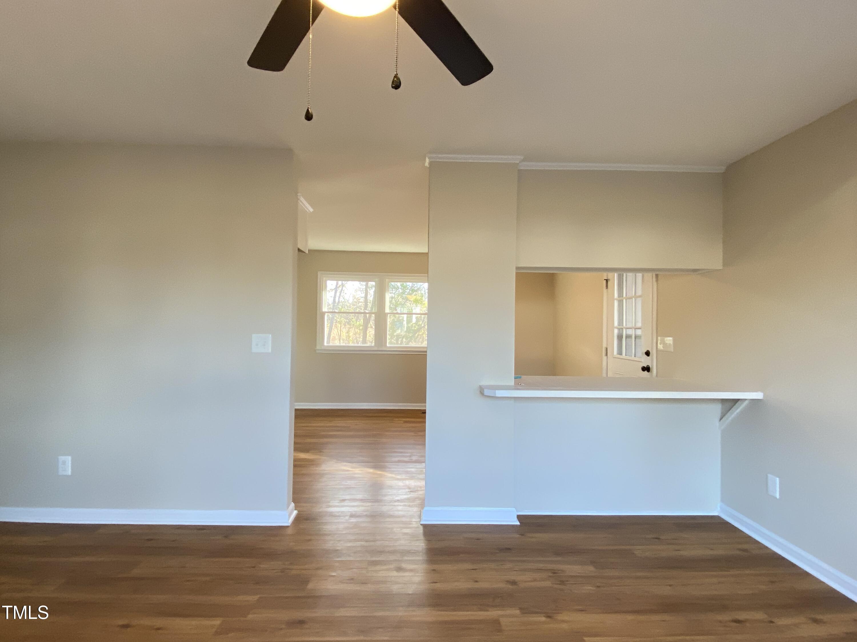 110 Sycamore Street Dunn, NC 28334 - Photo 5 of 28 a view of an empty room with window and wooden floor