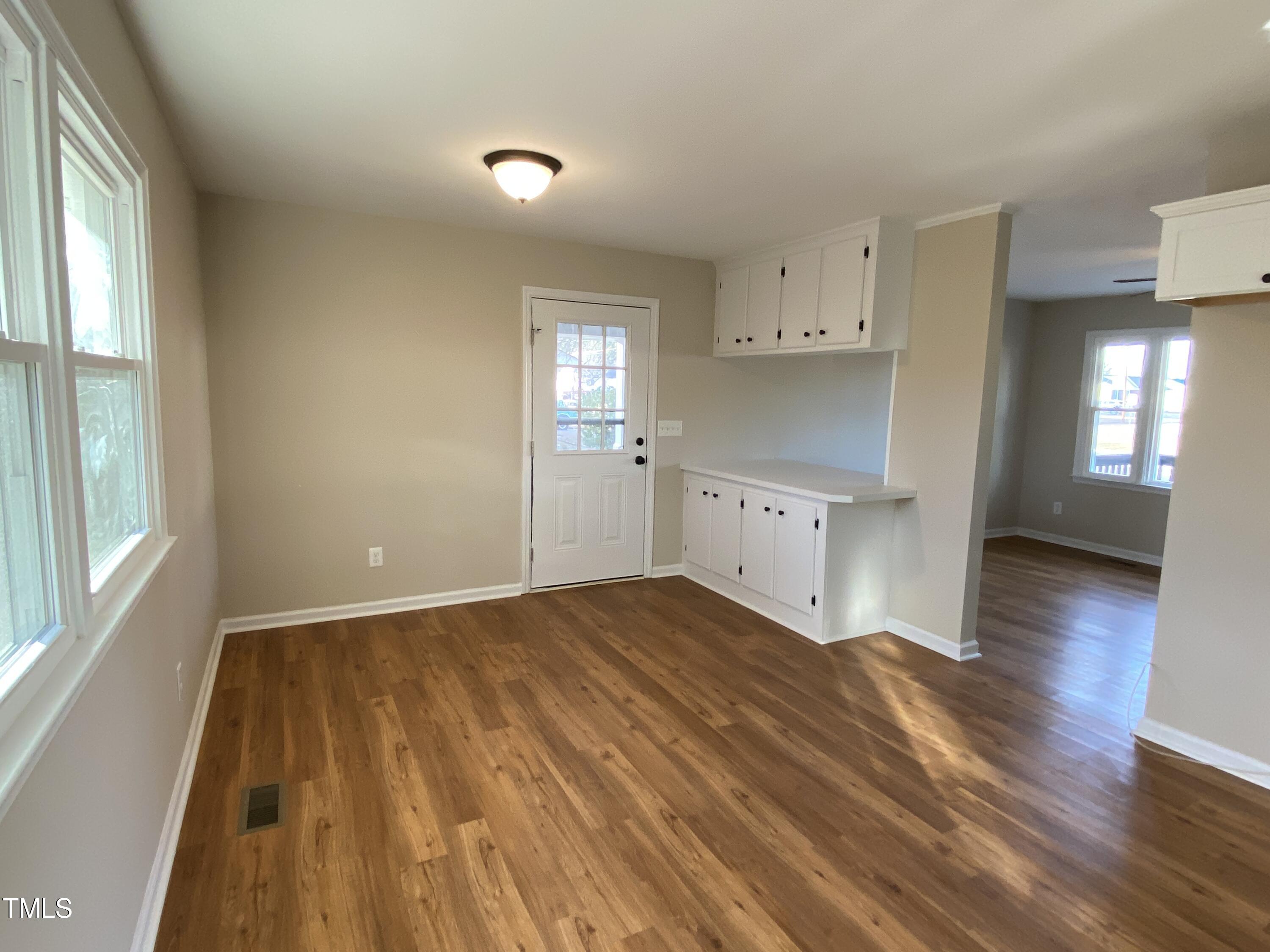 110 Sycamore Street Dunn, NC 28334 - Photo 9 of 28 a view of a kitchen with a sink and dishwasher with wooden floor