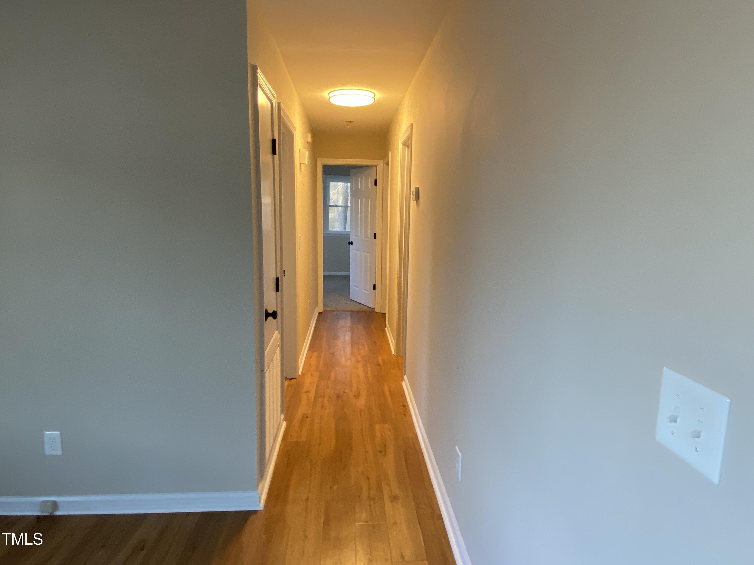 110 Sycamore Street Dunn, NC 28334 - Photo 10 of 28 a view of a hallway with wooden floor