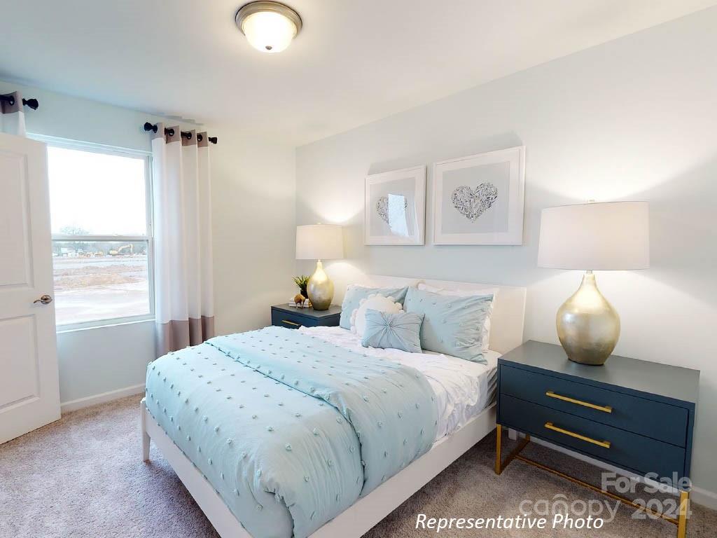 1207 Dan River Southwest, Unit 159 Concord, NC 28027 - Photo 11 of 13 a bedroom with bed and wooden floor