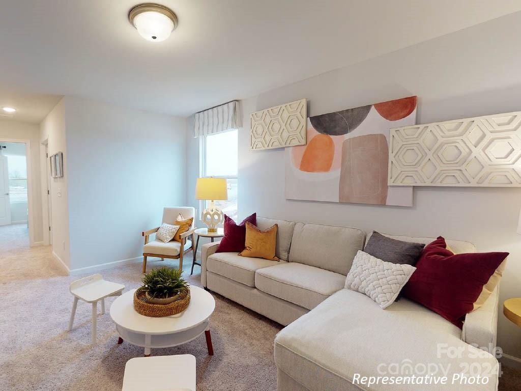 1207 Dan River Southwest, Unit 159 Concord, NC 28027 - Photo 8 of 13 a living room with furniture and a wooden floor