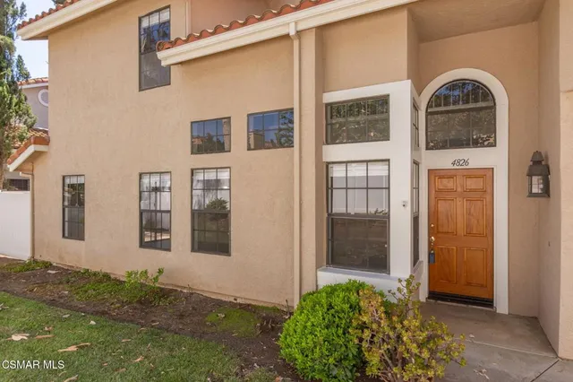 a view of a brick house with many windows