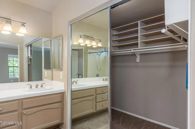 a bathroom with a double vanity sink and mirror