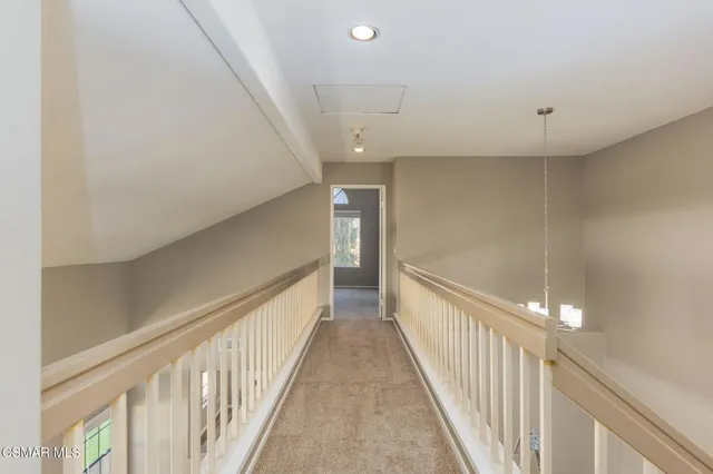 a view of a hallway with stairs