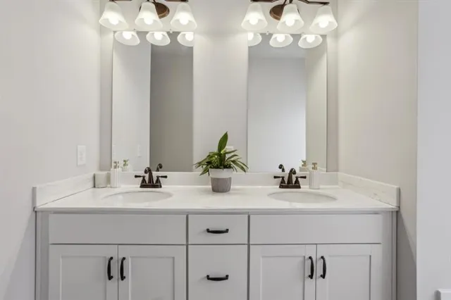 a bathroom with a sink vanity and a mirror