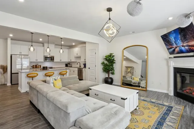 a living room with furniture kitchen view and a fireplace