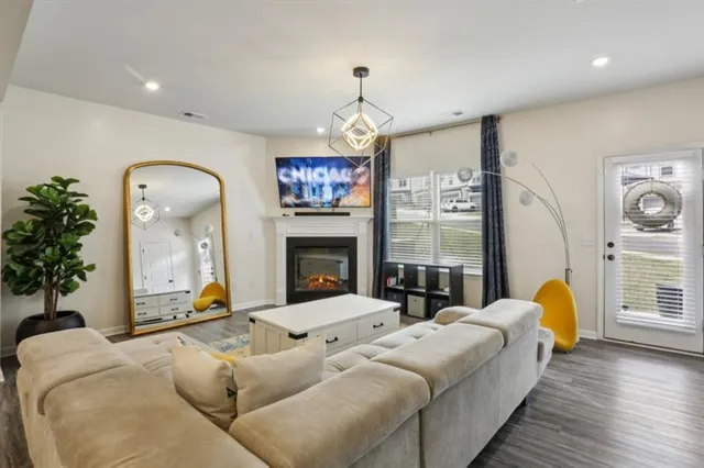 a living room with bed furniture and a fireplace