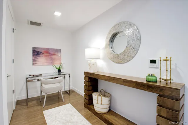 a living room with furniture and a mirror