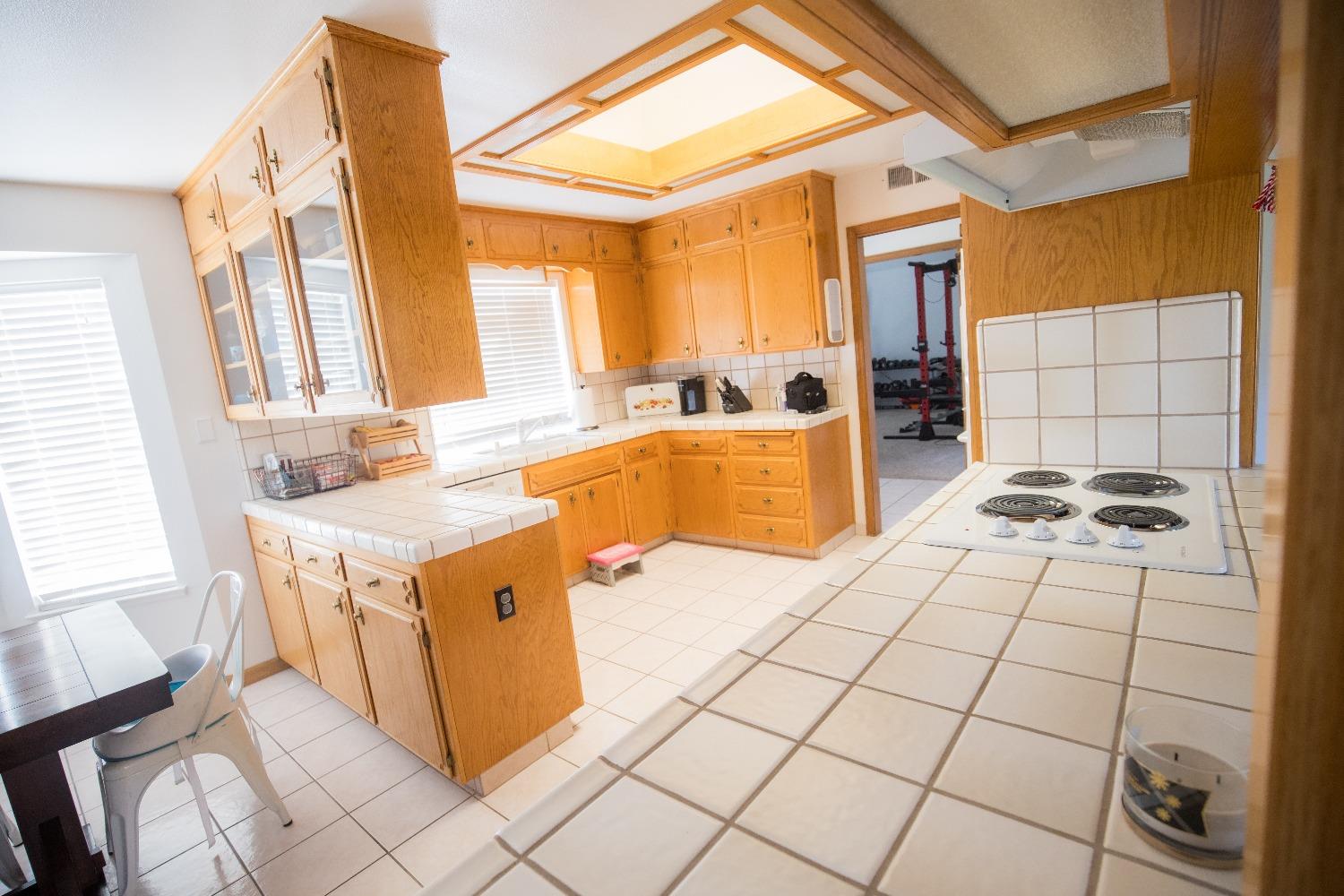 2544 Sterling Avenue Sanger, CA 93657 - Photo 11 of 27 a kitchen with a sink a stove top oven and cabinetry