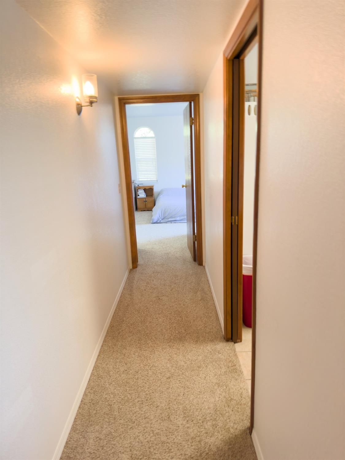 2544 Sterling Avenue Sanger, CA 93657 - Photo 24 of 27 a view of a hallway with wooden floor and a bathroom
