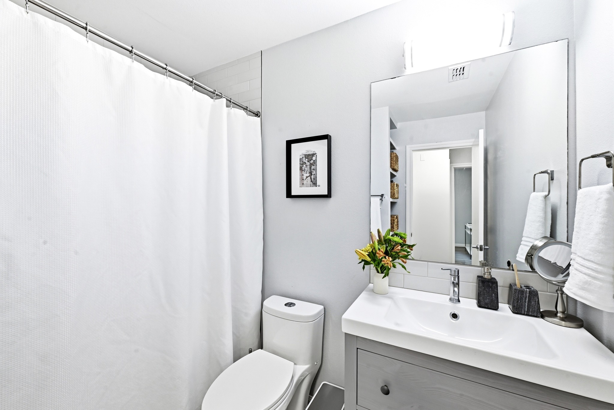 7110 Windrift Way Austin, TX 78745 - Photo 21 of 30 Functional full bathroom with a bright vanity and convenient shower space.