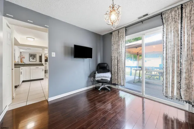a view of a livingroom with workspace and a window