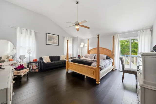 a bedroom with a bed couch and a window