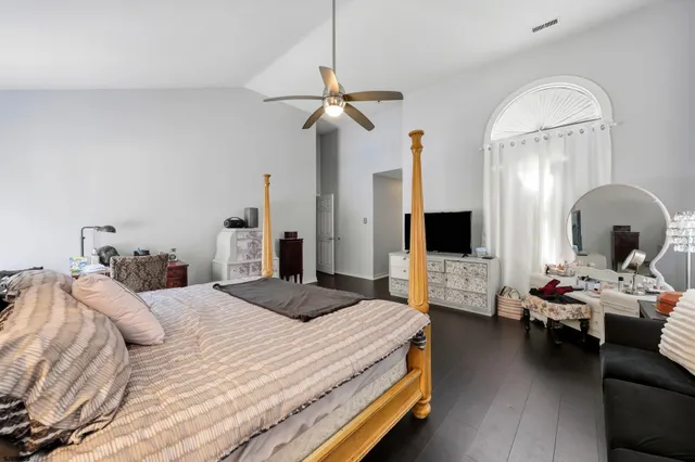 a bedroom with a bed couch and a window