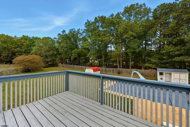 a view of balcony with wooden floor and fence