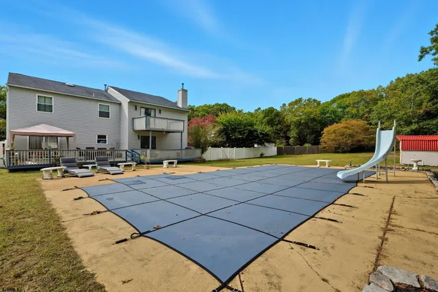 a swimming pool with outdoor seating and yard