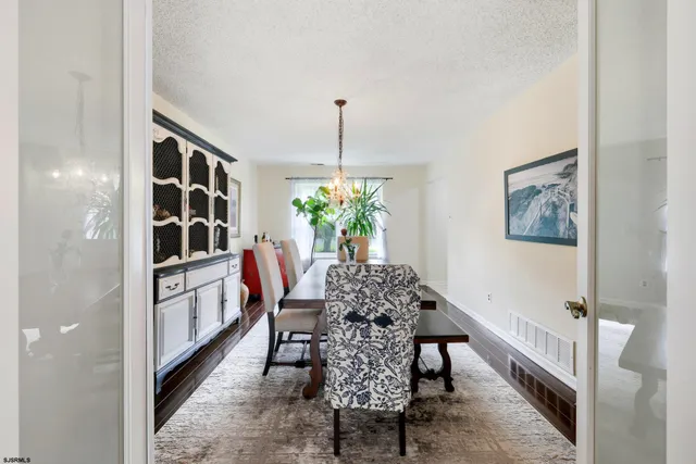a dining room with furniture and window