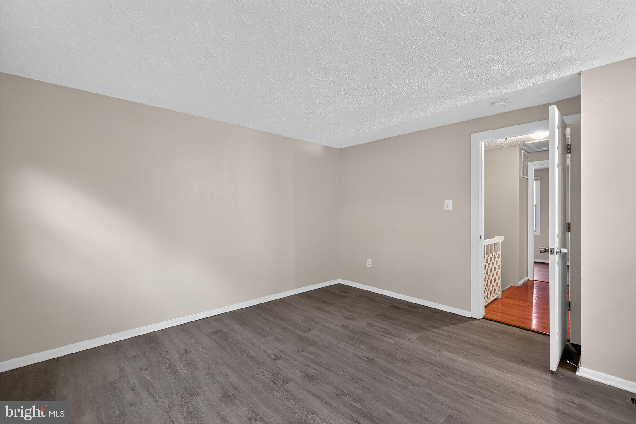 3602 Castle Terrace, Unit 116102 Silver Spring, MD 20904 - Photo 12 of 30 a view of an empty room with wooden floor