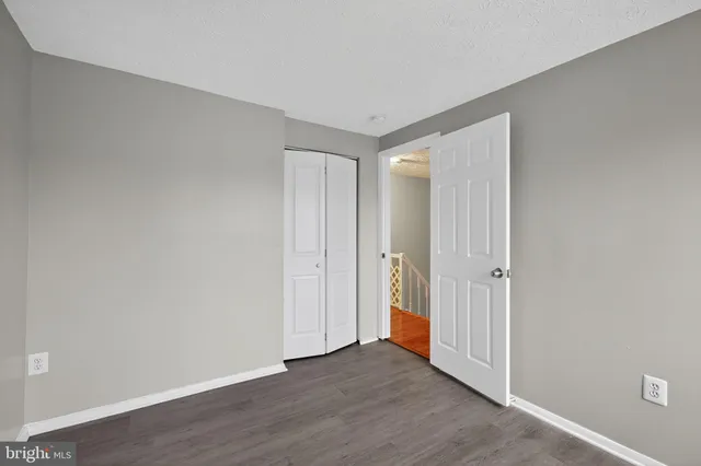 a view of an empty room and wooden floor