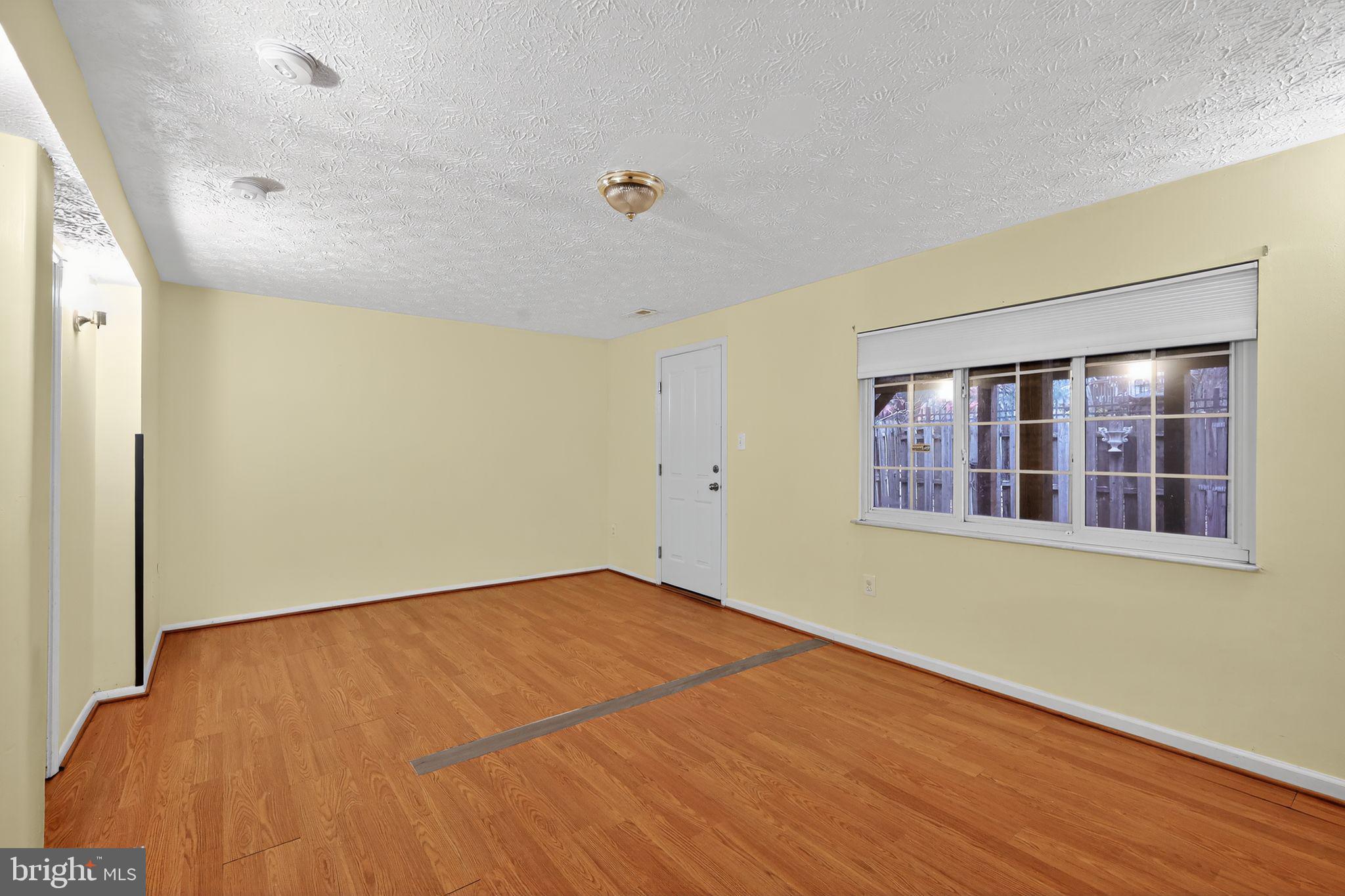 3602 Castle Terrace, Unit 116102 Silver Spring, MD 20904 - Photo 18 of 30 a view of empty room with wooden floor and fan