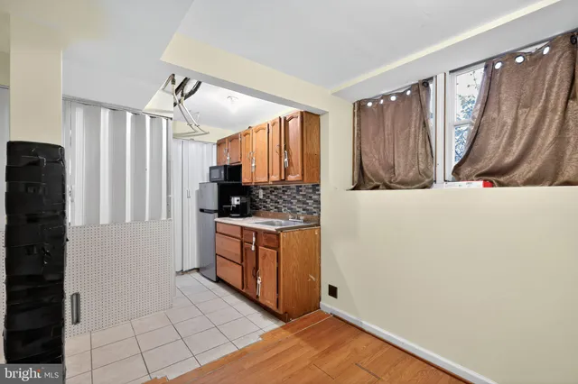 a kitchen with granite countertop a refrigerator and a stove top oven