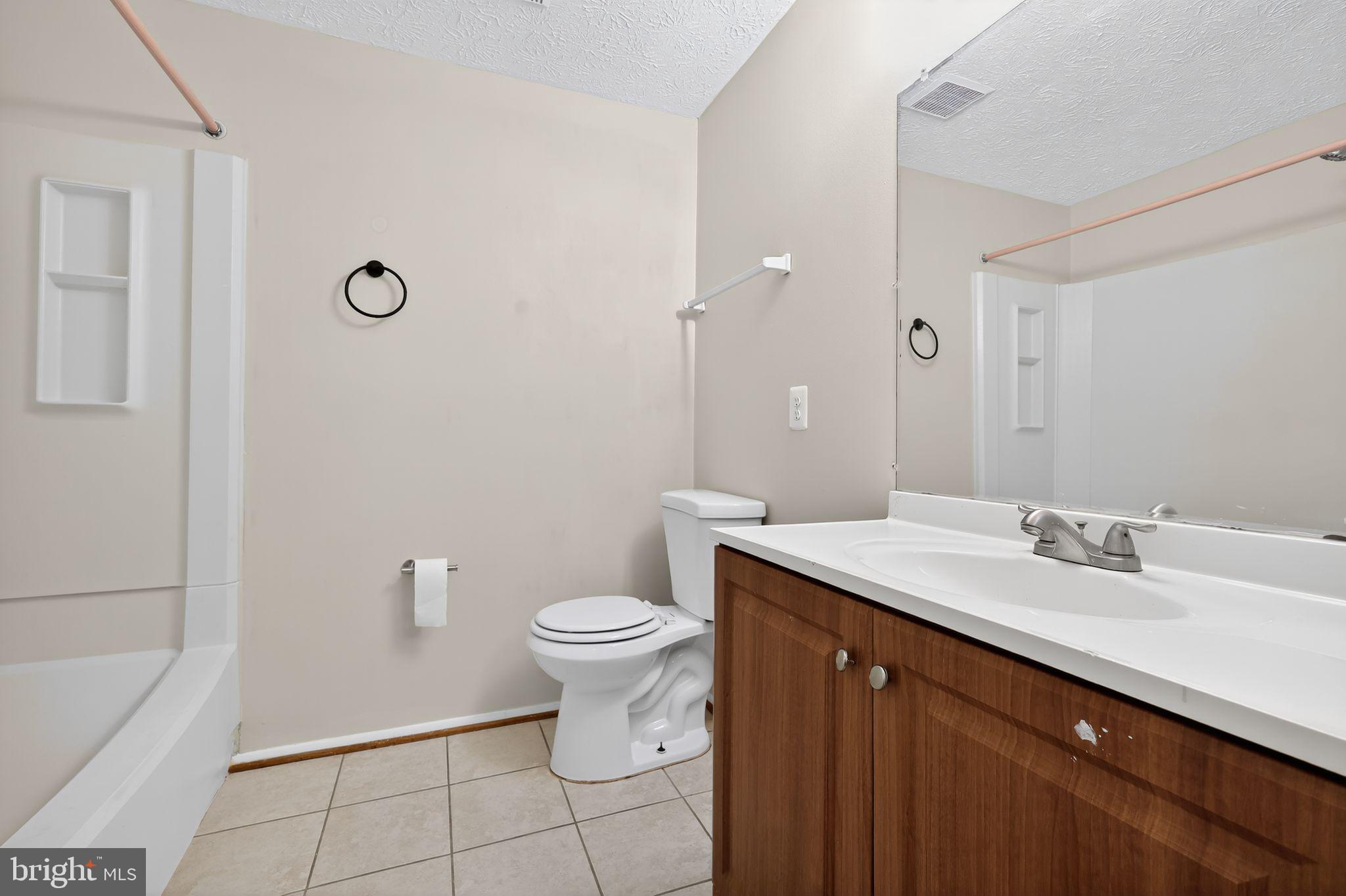 3602 Castle Terrace, Unit 116102 Silver Spring, MD 20904 - Photo 22 of 30 a bathroom with a sink a toilet and shower