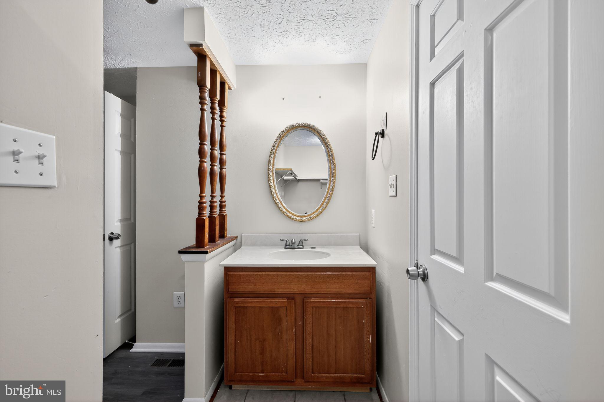 3602 Castle Terrace, Unit 116102 Silver Spring, MD 20904 - Photo 24 of 30 a bathroom with a sink and a mirror