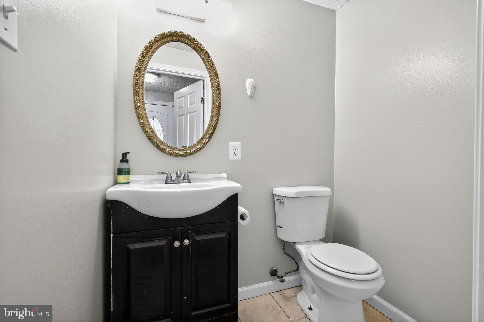 3602 Castle Terrace, Unit 116102 Silver Spring, MD 20904 - Photo 26 of 30 a bathroom with a sink a mirror and a toilet