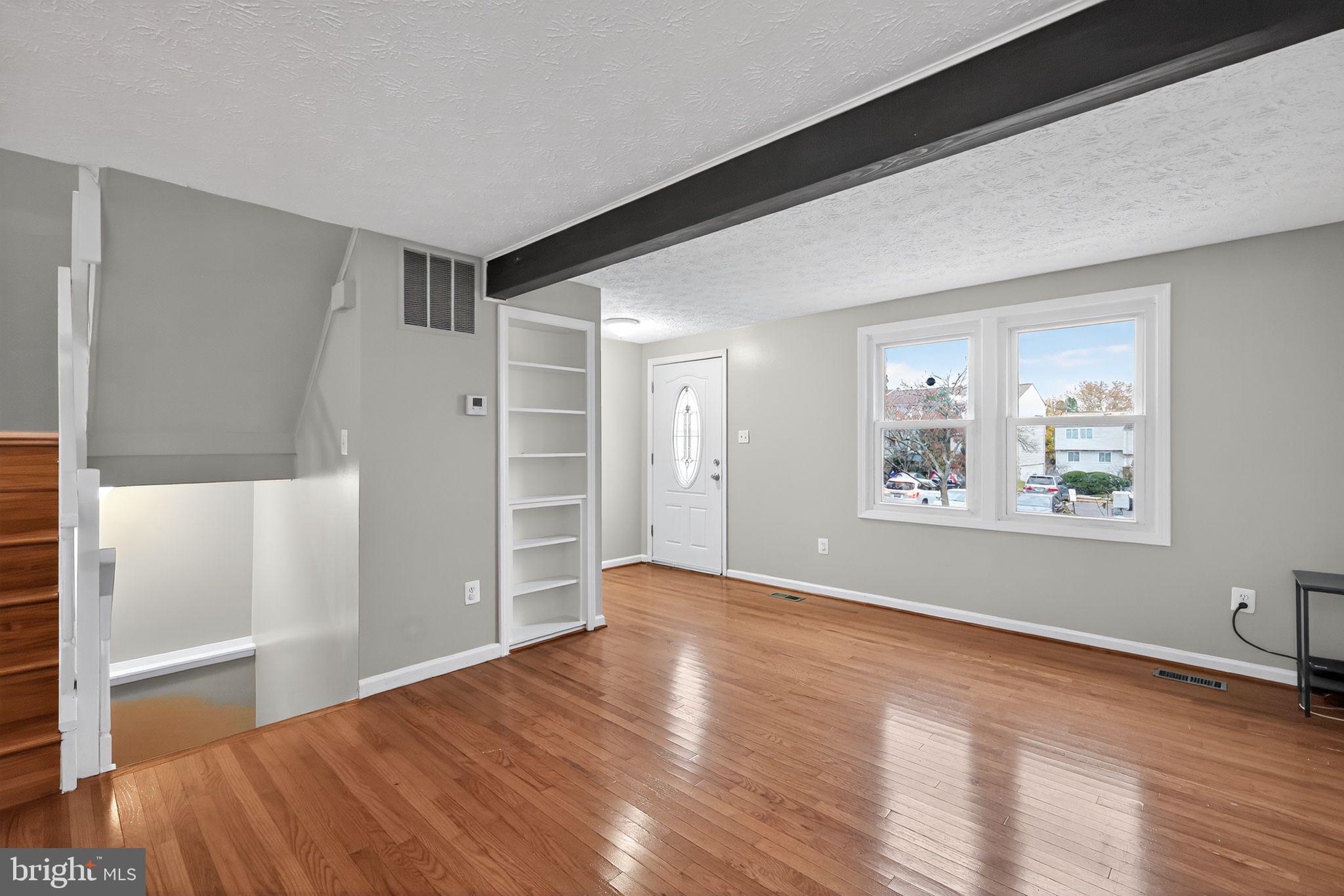 3602 Castle Terrace, Unit 116102 Silver Spring, MD 20904 - Photo 3 of 30 an empty room with wooden floor and windows